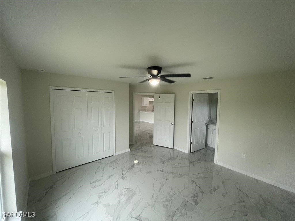 4524-4526 15th Street Southwest Lehigh Acres, FL 33973 - Photo 11 of 27 an empty room with fan and entrance