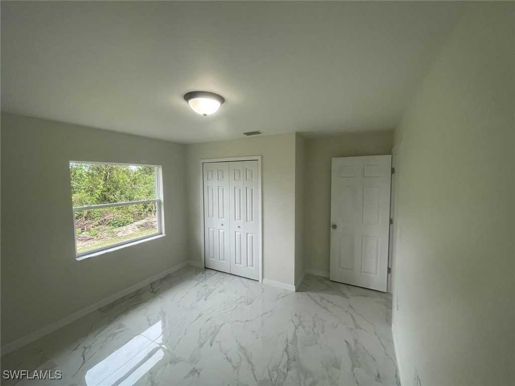 4524-4526 15th Street Southwest Lehigh Acres, FL 33973 - Photo 12 of 27 a view of an empty room with a window