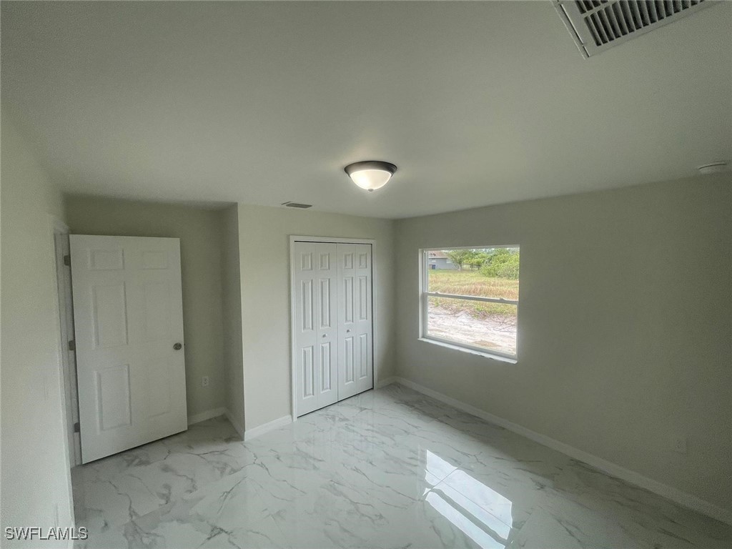 4524-4526 15th Street Southwest Lehigh Acres, FL 33973 - Photo 14 of 27 an empty room with windows