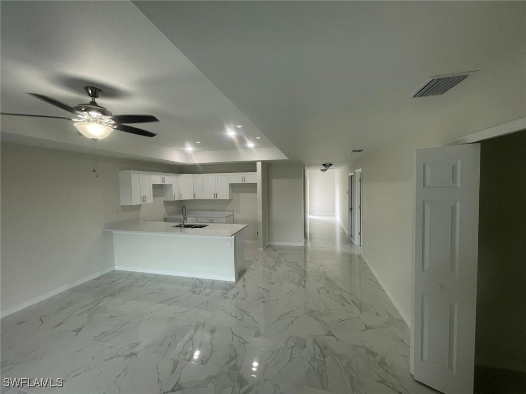 4524-4526 15th Street Southwest Lehigh Acres, FL 33973 - Photo 6 of 27 a view of a kitchen with a sink and a refrigerator