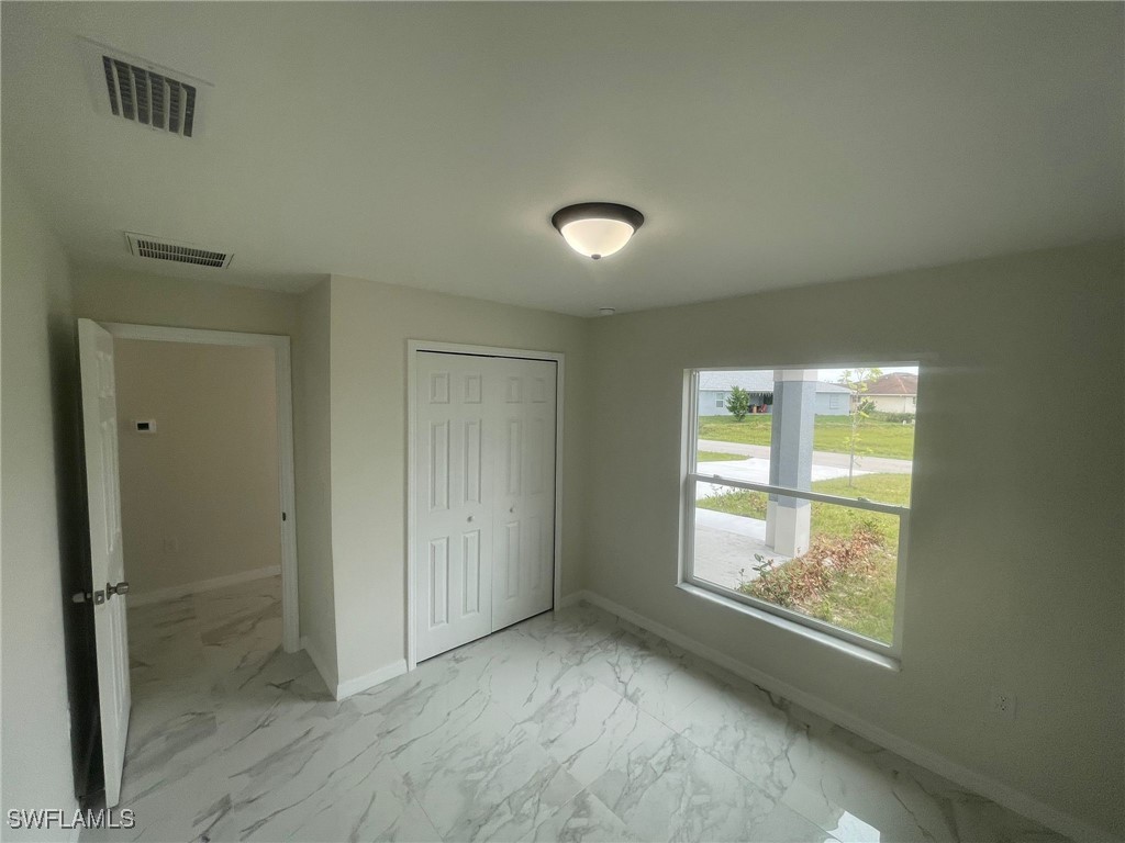 4524-4526 15th Street Southwest Lehigh Acres, FL 33973 - Photo 10 of 27 an empty room with windows and mirror