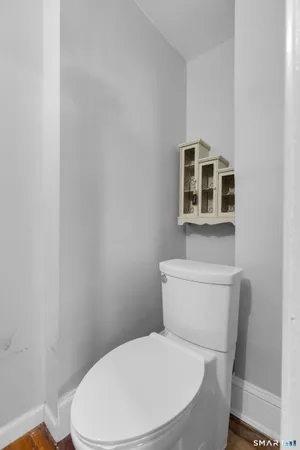 a white toilet sitting next to a bathroom sink