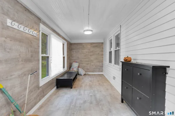 a view of entryway with window and hardwood floor