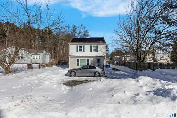 a view of a house with a snow in the yard