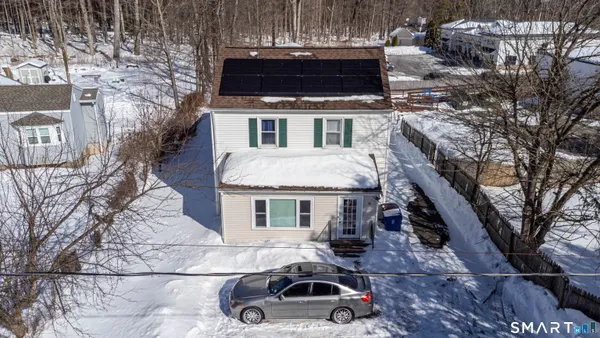 a house with tall trees in front of it
