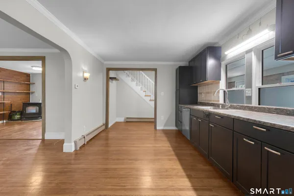 a large kitchen with granite countertop a oven and a sink