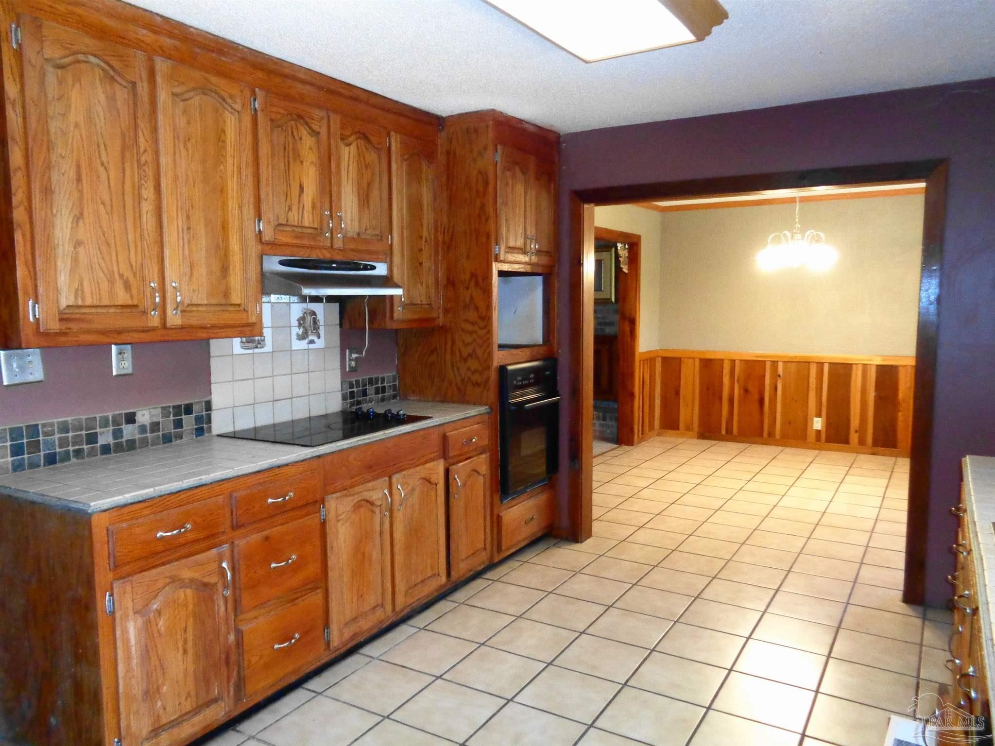 252 S Road Atmore, AL 36502 - Photo 25 of 40 a kitchen with stainless steel appliances a refrigerator and cabinets