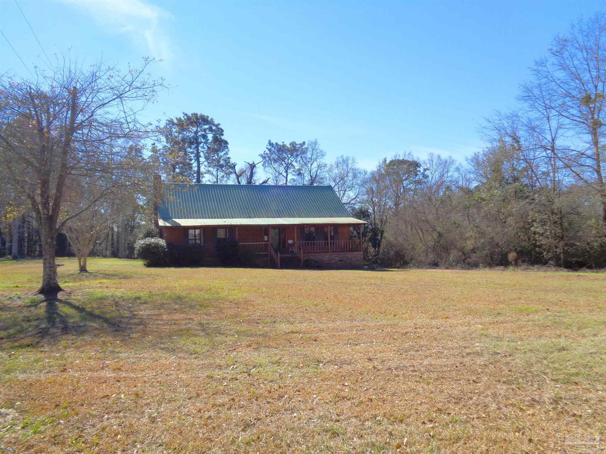 252 S Road Atmore, AL 36502 - Photo 40 of 40 a building with trees in the background