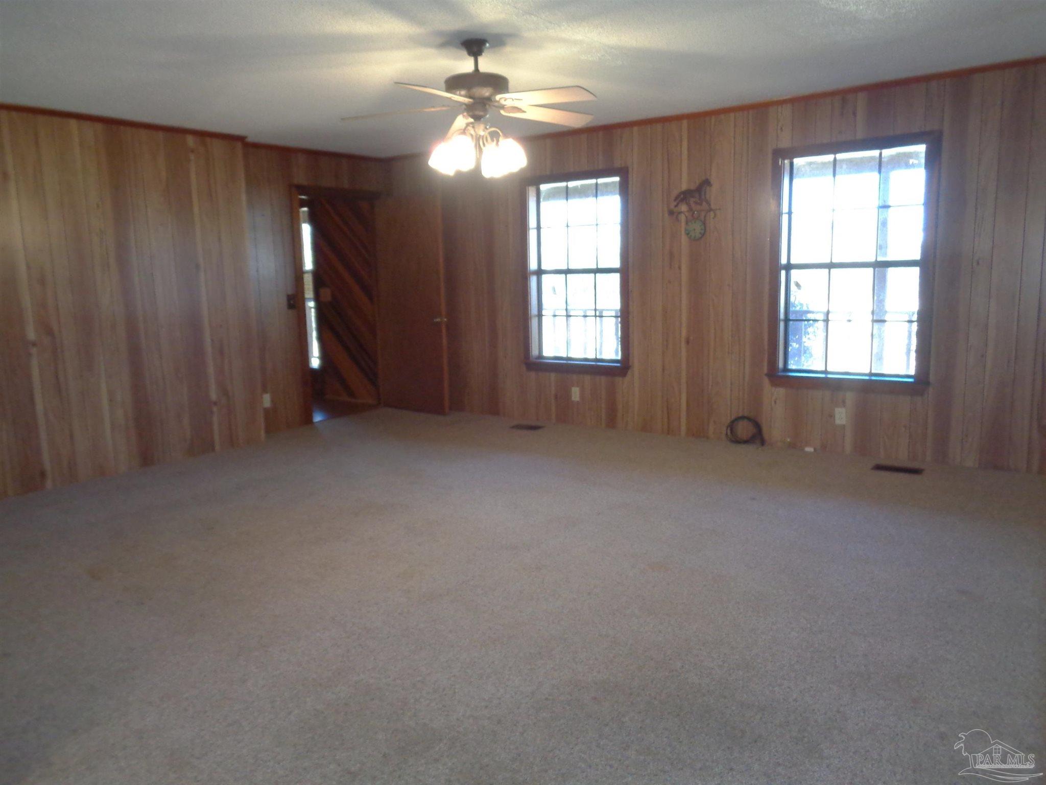 252 S Road Atmore, AL 36502 - Photo 7 of 40 an empty room with windows and fan