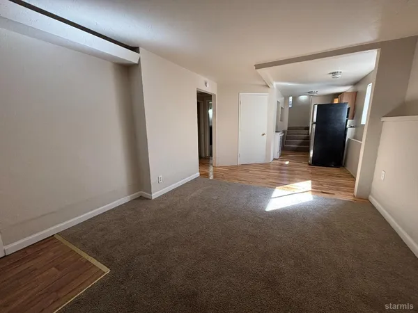 a view of an empty room and a fireplace