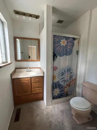 an empty room with windows and closet