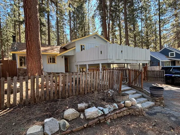 a backyard of a house with barbeque oven and outdoor seating