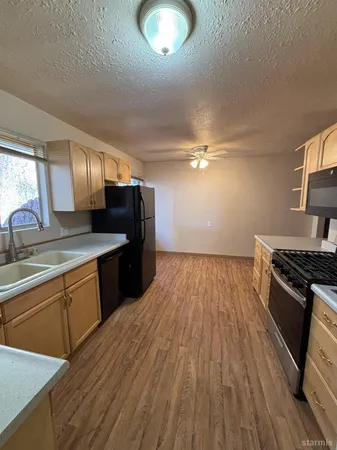 a kitchen with granite countertop a stove and a sink