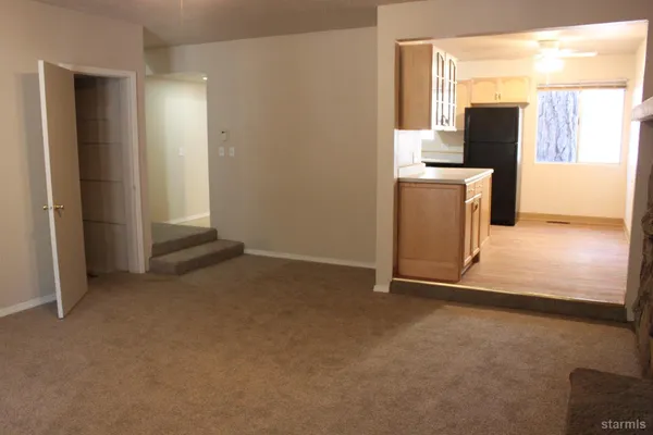 a view of a kitchen with a sink and a refrigerator