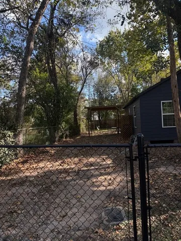 a view of a yard with large trees
