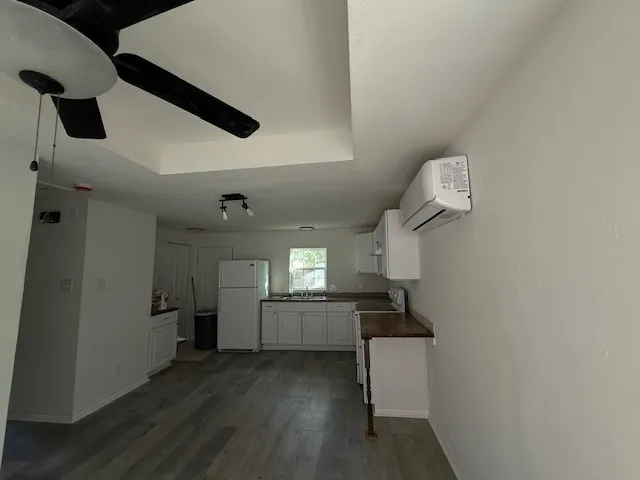 a kitchen with a refrigerator and a sink