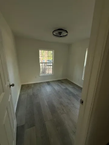 a bathroom with a granite countertop toilet and a sink