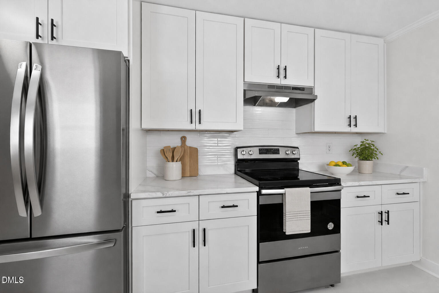 302 Normandy Street Durham, NC 27707 - Photo 11 of 29 a kitchen with white cabinets and refrigerator