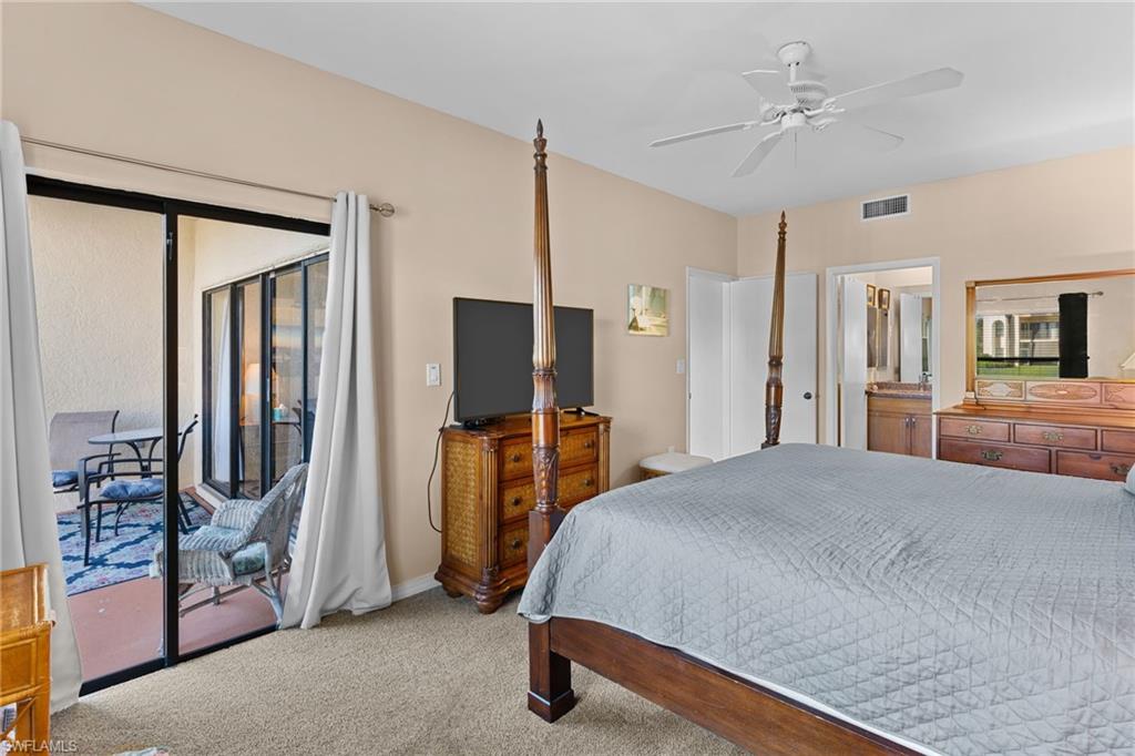 3324 Olympic Drive, Unit 313 Naples, FL 34105 - Photo 17 of 43 a bedroom with a bed and a mirror