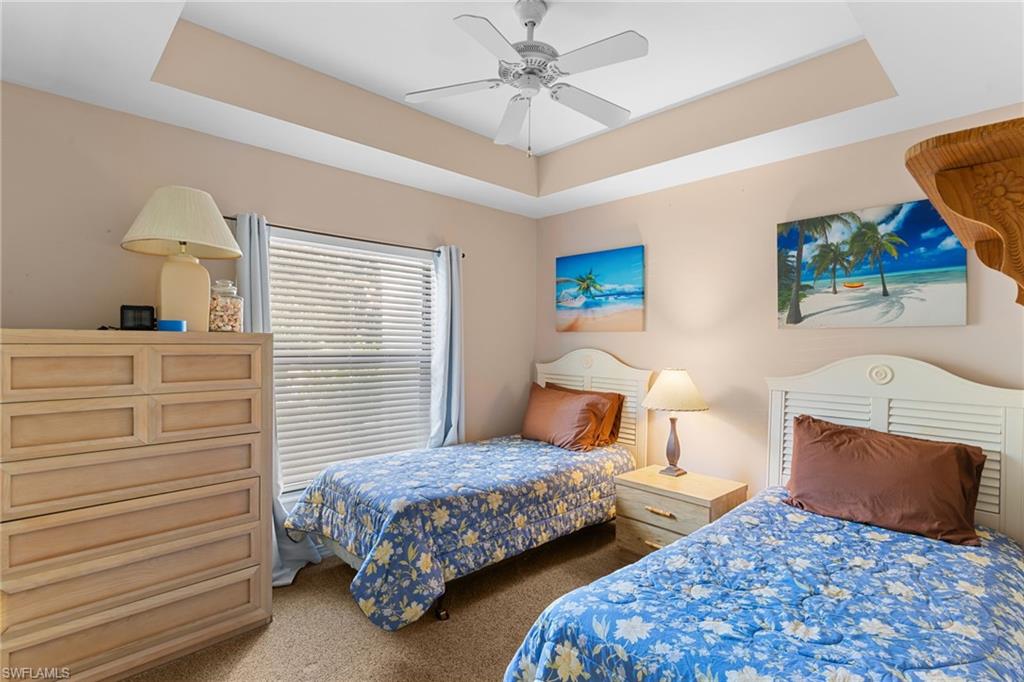 3324 Olympic Drive, Unit 313 Naples, FL 34105 - Photo 19 of 43 a bedroom with two beds and painting on the wall