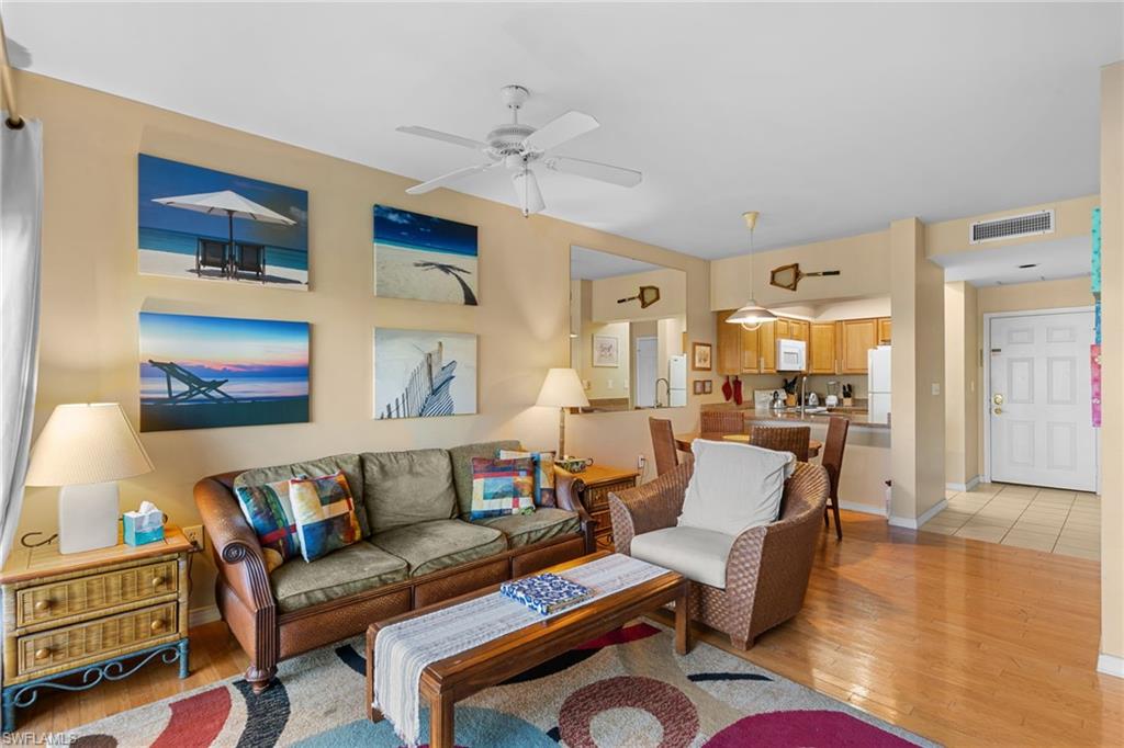 3324 Olympic Drive, Unit 313 Naples, FL 34105 - Photo 43 of 43 a living room with furniture kitchen view and a chandelier
