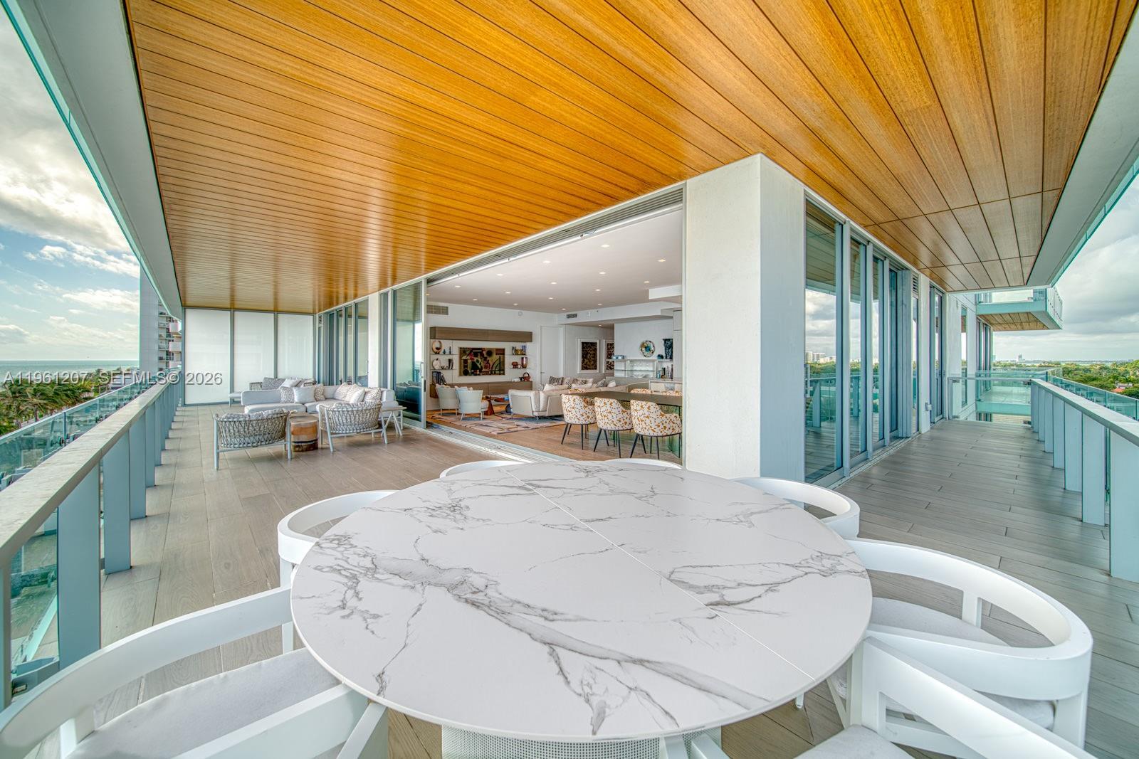 5775 Collins Avenue, Unit 703 Miami Beach, FL 33140 - Photo 13 of 44 a large room with pool table and windows