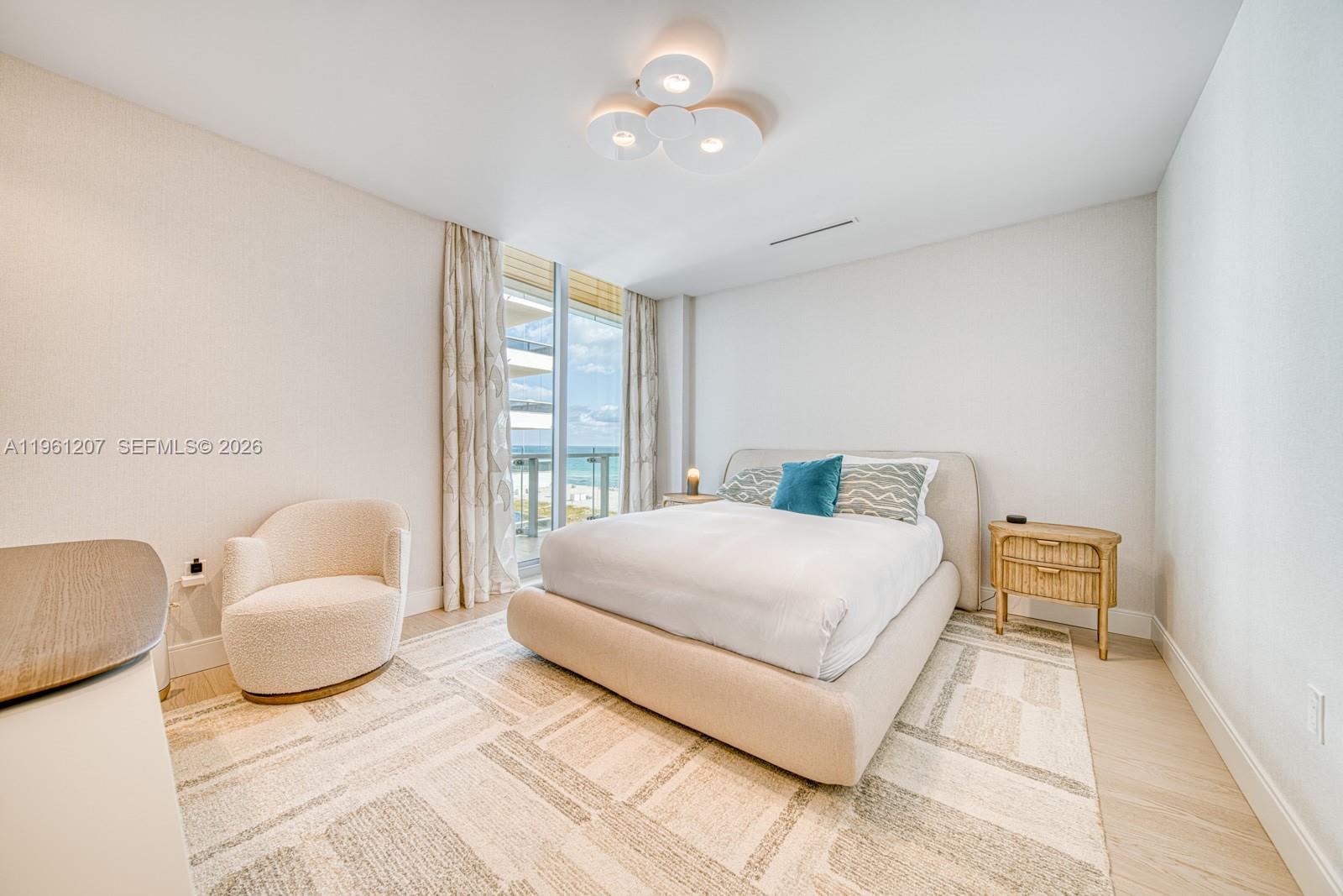 5775 Collins Avenue, Unit 703 Miami Beach, FL 33140 - Photo 31 of 44 a bedroom with a bed and lamp