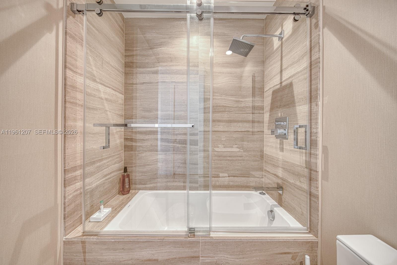 5775 Collins Avenue, Unit 703 Miami Beach, FL 33140 - Photo 36 of 44 a bathroom with a tub