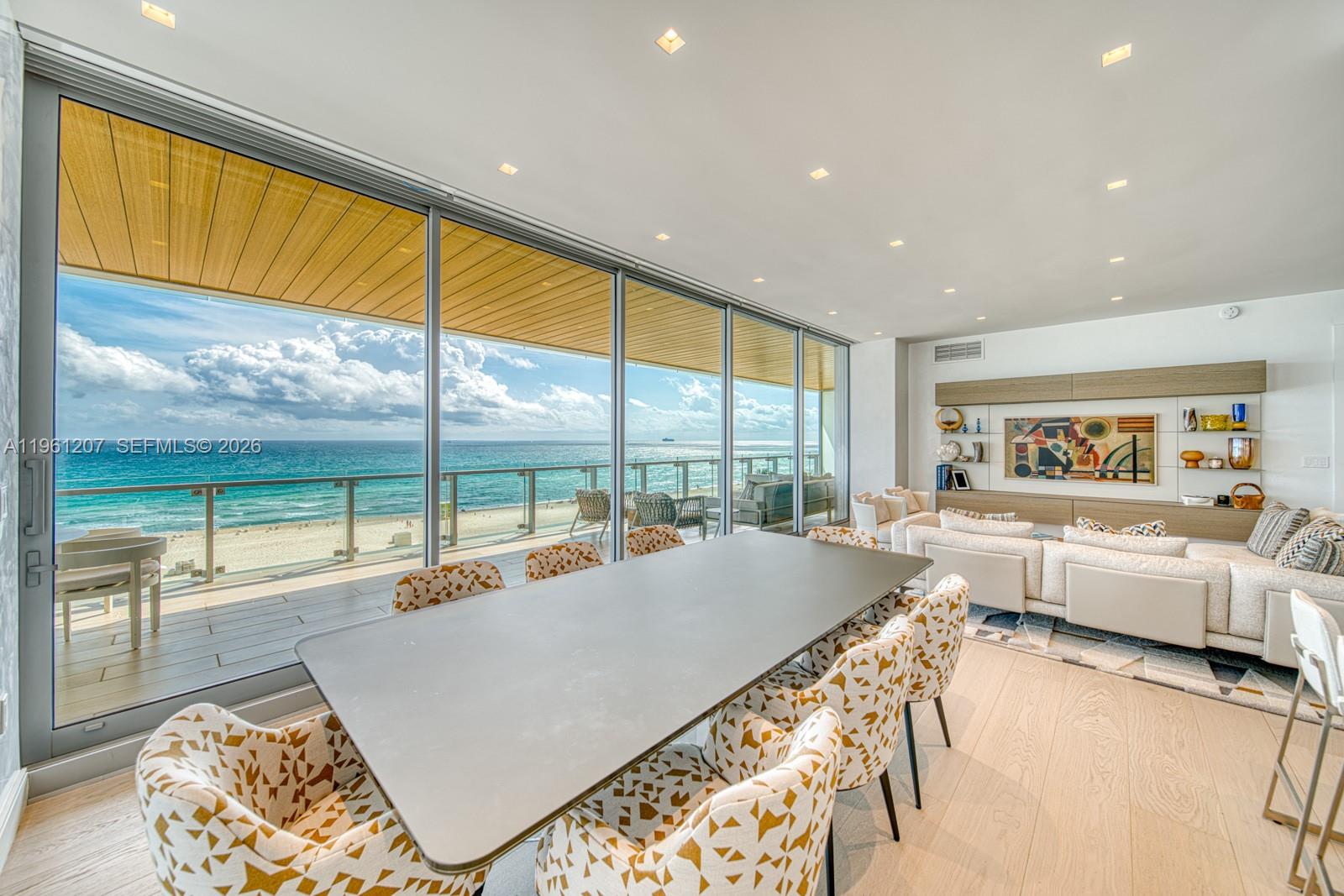 5775 Collins Avenue, Unit 703 Miami Beach, FL 33140 - Photo 9 of 44 a living room with furniture and a large window