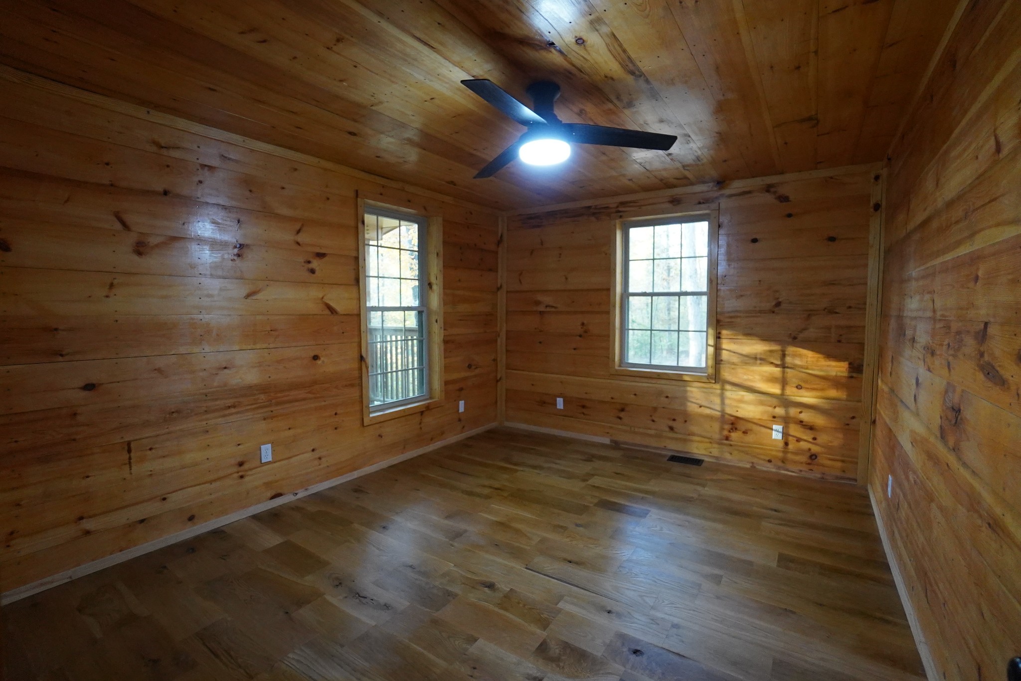 188 Woods Road Dover, TN 37058 - Photo 9 of 31 an empty room with wooden floor and windows