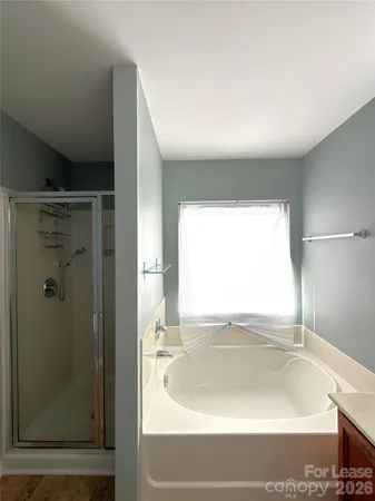 a bathroom with a bathtub and a shower