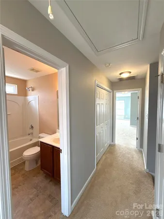 a bathroom with a toilet sink and a mirror