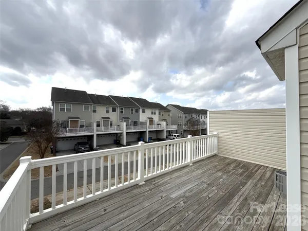 a view of balcony with wooden floor and fence