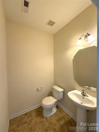 a bathroom with a sink mirror and toilet