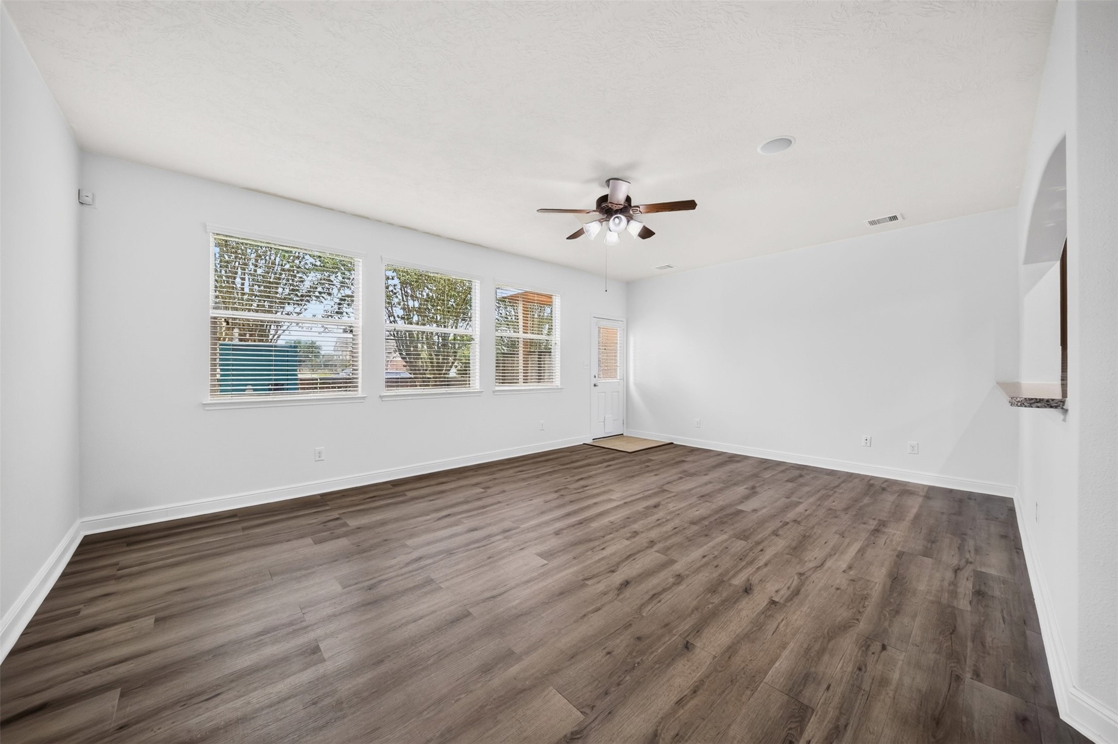 10510 Day Trail Lane Spring, TX 77379 - Photo 11 of 28 Enjoy a bright, sun-drenched living room that exemplifies modern comfort and stylish, open-concept living with a door leading out onto the patio.
