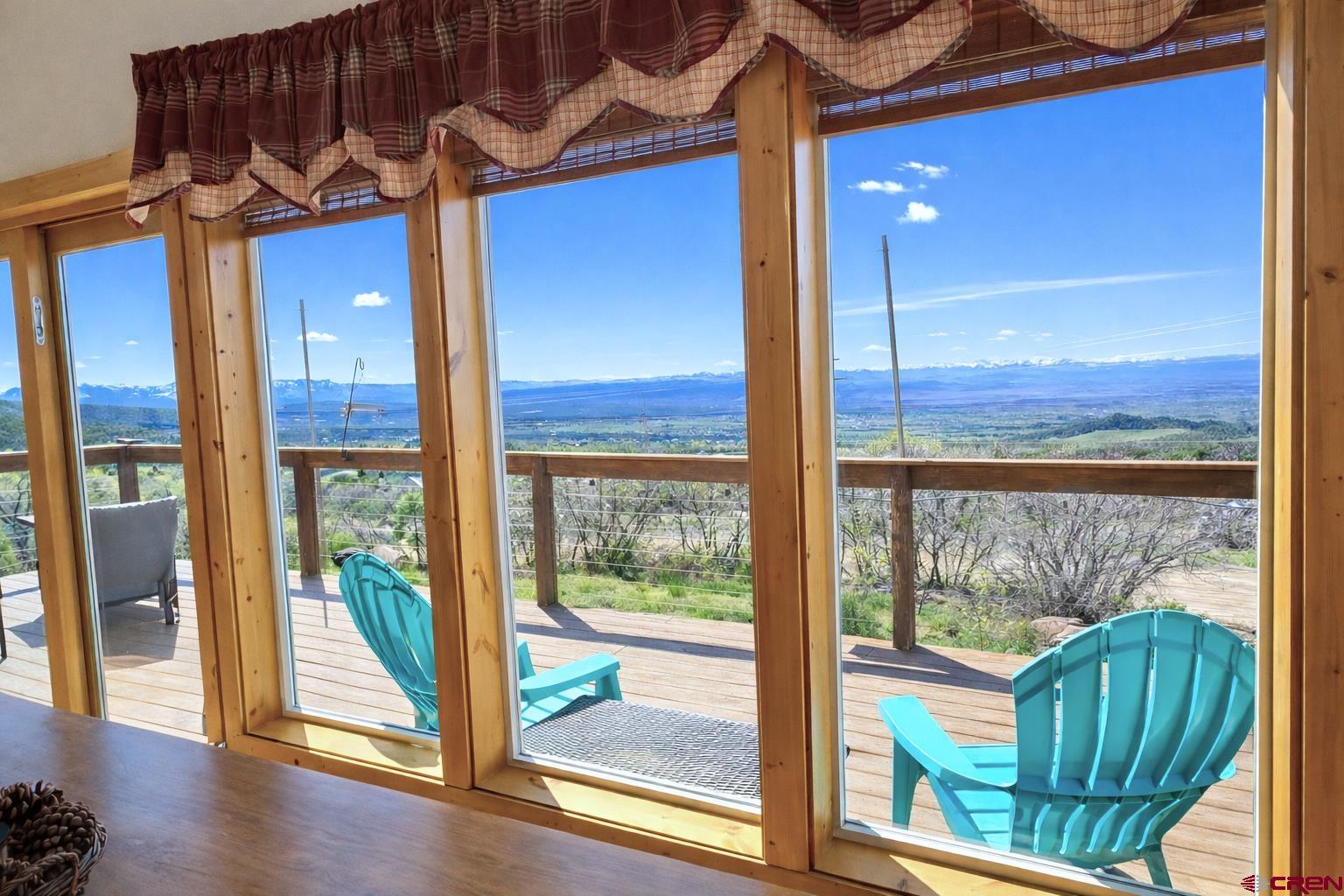 21976 2225th Road Cedaredge, CO 81413 - Photo 6 of 36 a view of a porch with furniture and wooden floor