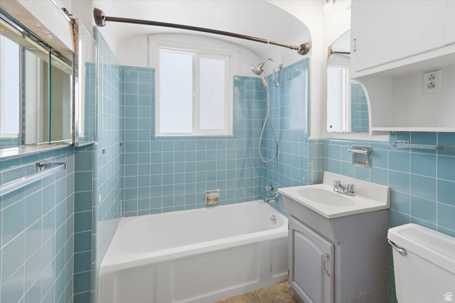 744 North 500 East Logan, UT 84321 - Photo 14 of 29 Upstairs Full bath featuring tile walls, vanity, and bathtub / shower combination