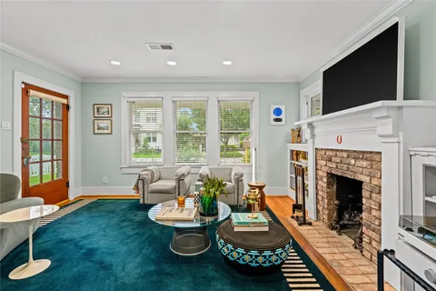 a living room with furniture a flat screen tv and a fireplace
