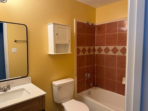 5637 Lotus Street Houston, TX 77085 - Photo 11 of 14 a bathroom with a bathtub shower sink vanity and toilet