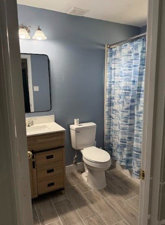 5637 Lotus Street Houston, TX 77085 - Photo 12 of 14 a bathroom with a toilet a sink and mirror