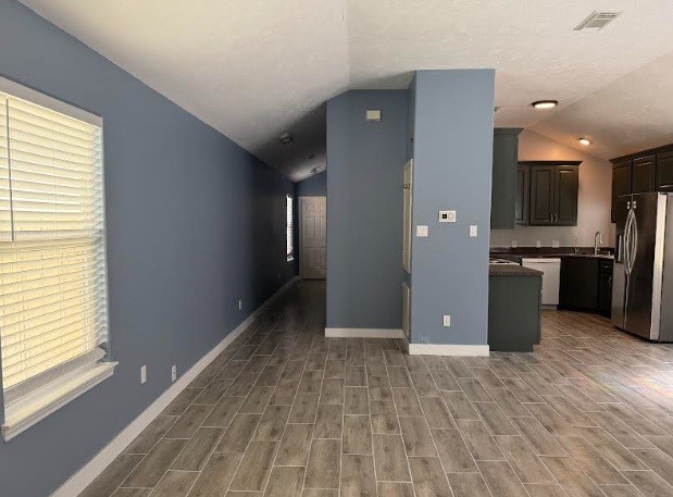 5637 Lotus Street Houston, TX 77085 - Photo 5 of 14 a view of a kitchen with a sink and a refrigerator
