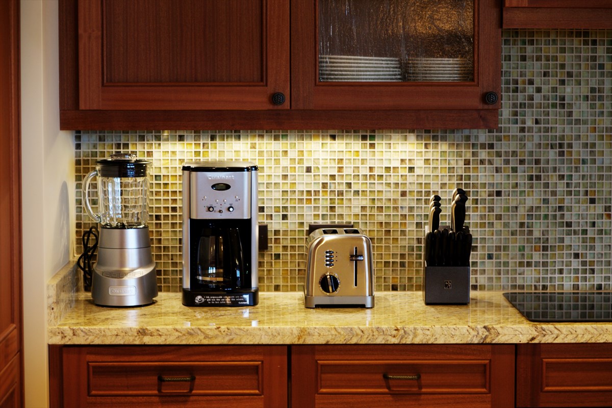 2641 Poipu Road, Unit 1401 Koloa, HI 96756 - Photo 5 of 12 a kitchen with granite countertop stainless steel appliances and cabinets