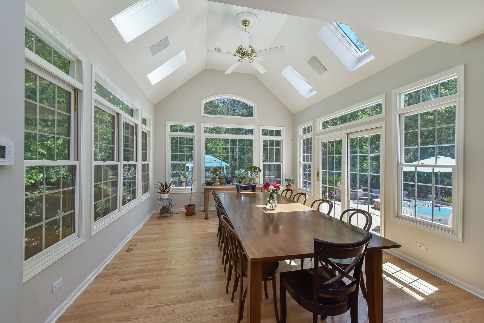 32W595 Oak Lawn Farm Road Wayne, IL 60184 - Photo 11 of 47 a view of a dining room with furniture large windows and wooden floor