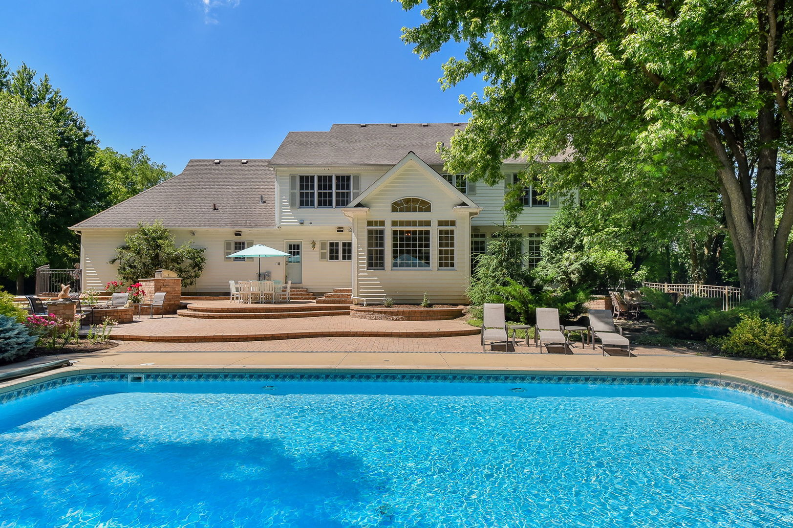 32W595 Oak Lawn Farm Road Wayne, IL 60184 - Photo 3 of 47 a front view of a house with swimming pool garden and patio