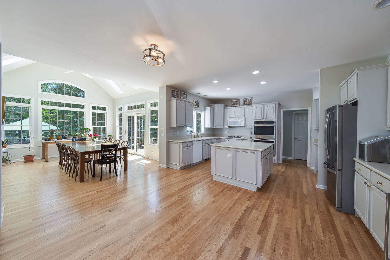 32W595 Oak Lawn Farm Road Wayne, IL 60184 - Photo 8 of 47 a large kitchen with a table and chairs in it