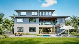 a view of a house with backyard porch and sitting area