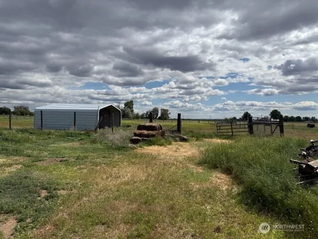 a view of a big yard with table and chairs