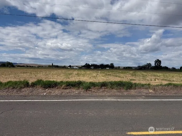 a room with stainless steel appliances a stove a refrigerator and furniture