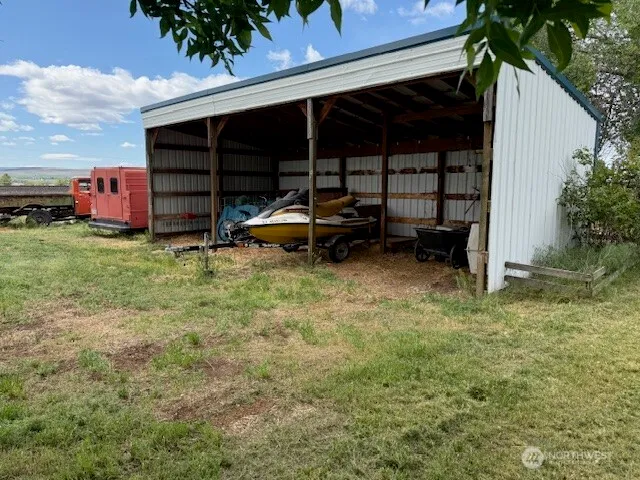 a view of a house with a yard and sitting area