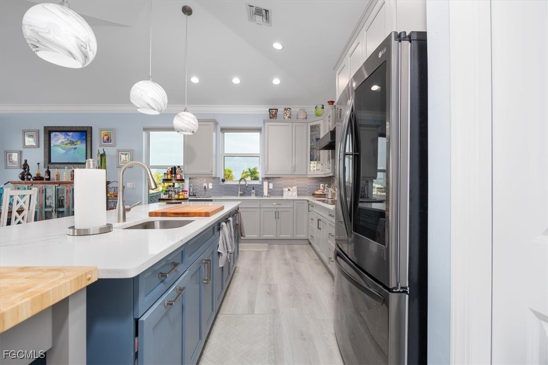 8425 Lagoon Road Fort Myers Beach, FL 33931 - Photo 11 of 49 a kitchen with cabinets a sink and stainless steel appliances